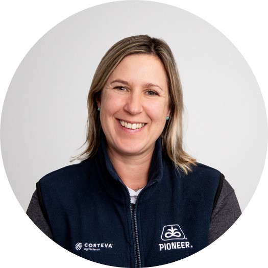 Beckie Blakemore, Corteva UK forage specialist, smiling in branded navy vest over gray top on white background.