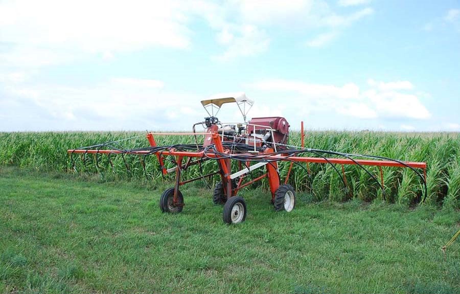 A high-clearance sprayer modified to seed cover crops into standing corn.