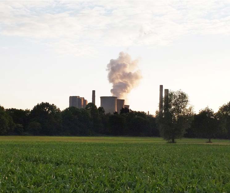 Photo - Factory complex with smoke from smokstacks