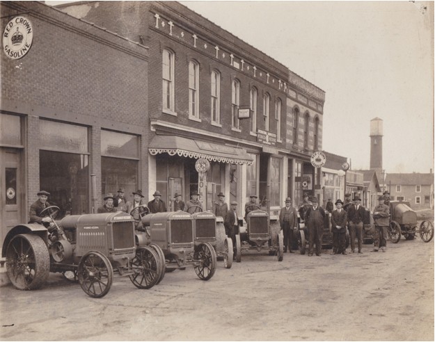 A group of farmers taking delivery of new tractors